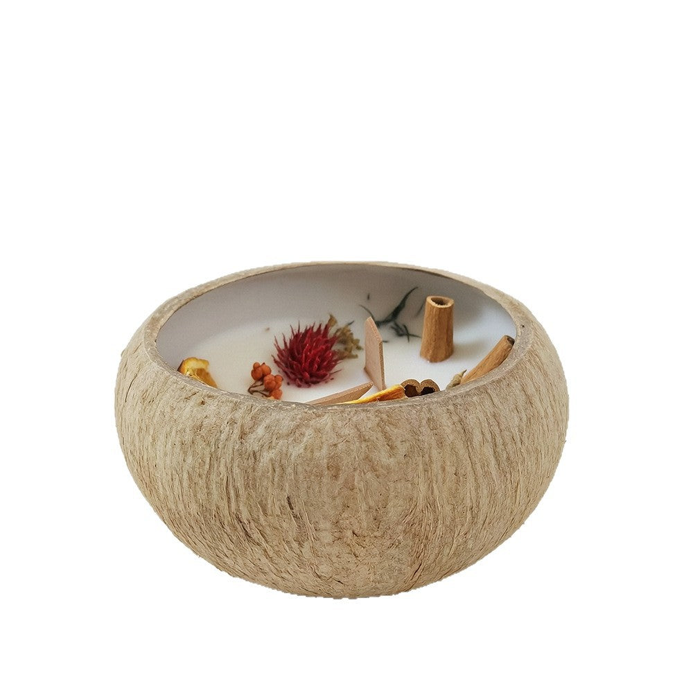 Coconut Shell Botanical Candle — candle in a natural coconut shell on white