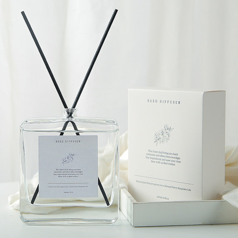 Minimalist Reed Diffuser — clear square glass bottle with black reeds beside its white gift box