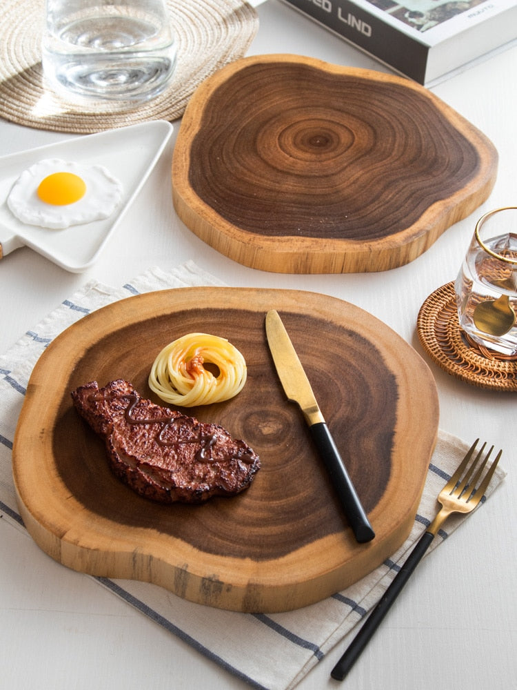 Acacia Tree Stump Board — on the table with a meal