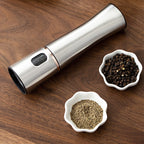 Electric Salt & Pepper Grinder — brushed steel grinder on a walnut board with peppercorns