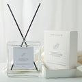 Minimalist Reed Diffuser — clear square glass bottle with black reeds beside its white gift box