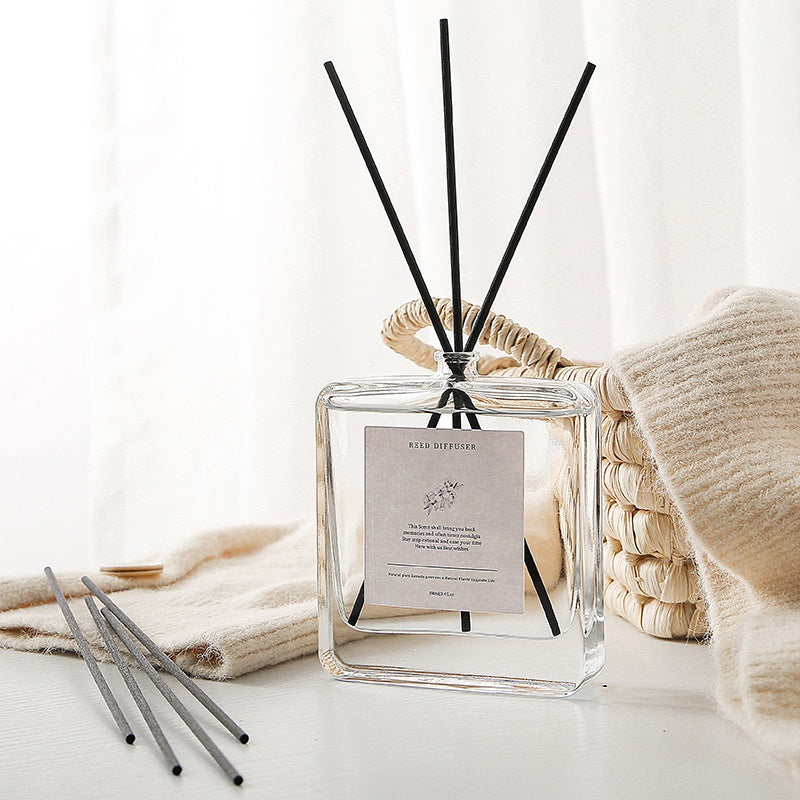 Minimalist Reed Diffuser — bottle with reeds on soft linen