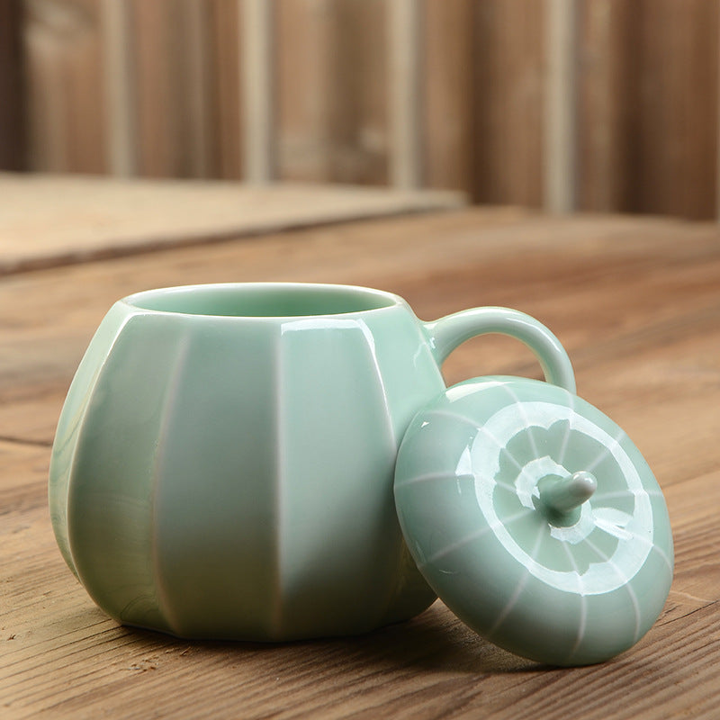 Sage ceramic pumpkin mug on a wooden table