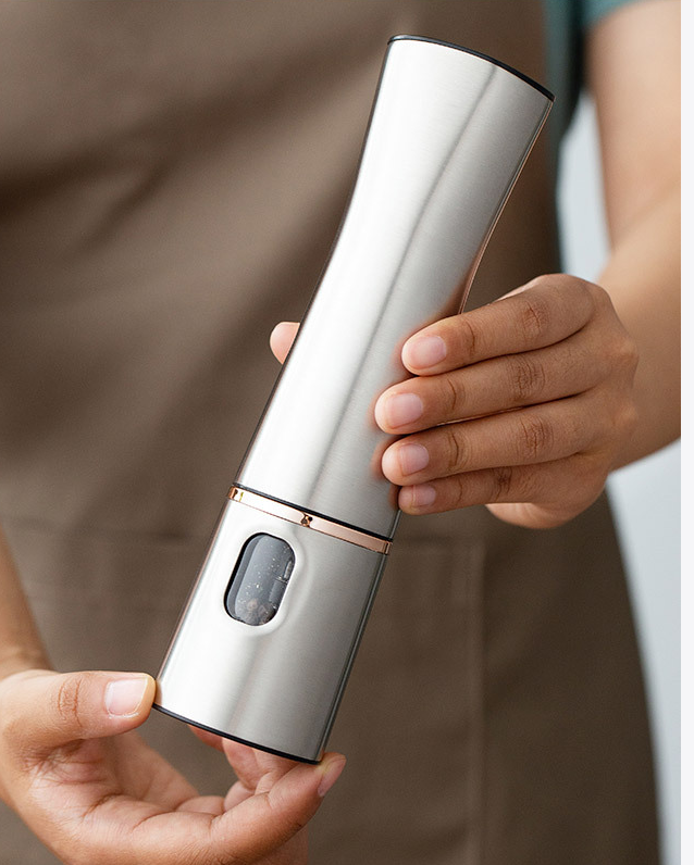 Electric Salt & Pepper Grinder — held in one hand