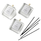 Minimalist Reed Diffuser — flat lay of bottles and black reeds